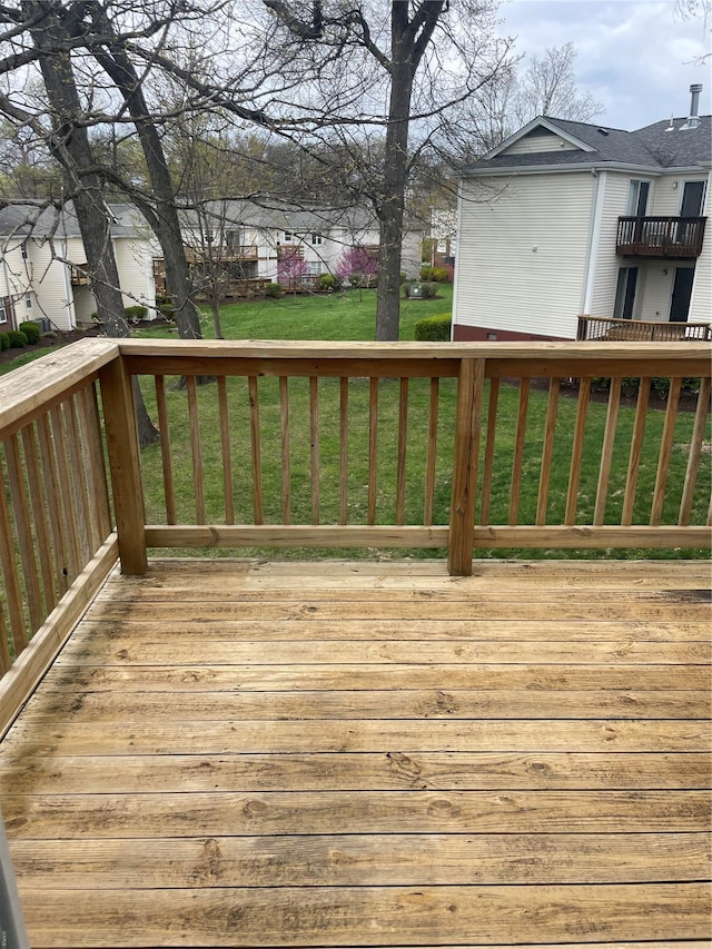wooden deck with a lawn