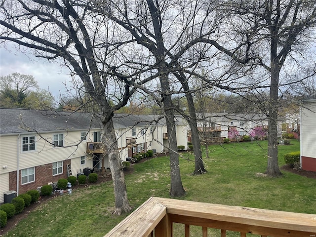 view of yard with central AC and a residential view