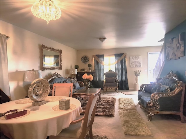 dining area featuring carpet and a chandelier