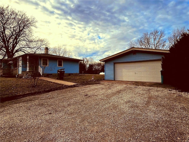 exterior space with a garage and an outdoor structure