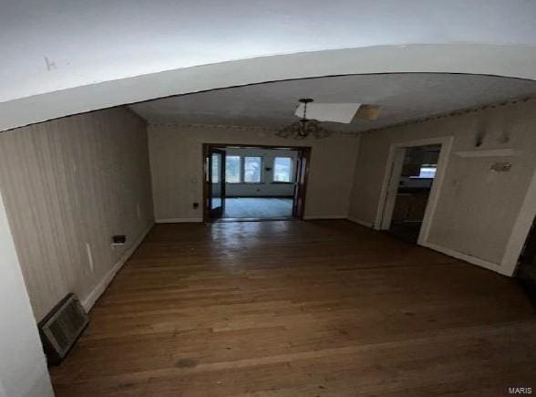 interior space featuring wood finished floors, visible vents, and an inviting chandelier