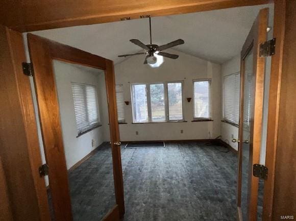 empty room featuring vaulted ceiling and ceiling fan