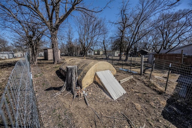 view of storm shelter with fence