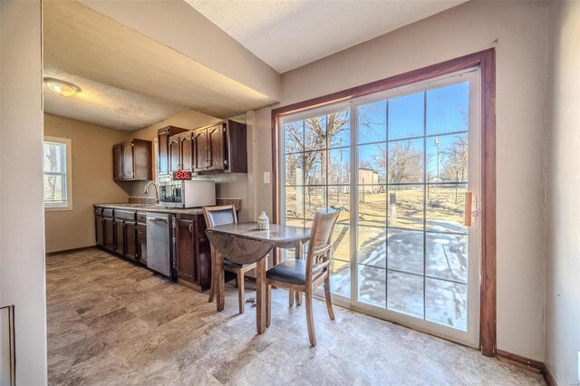 dining area featuring baseboards and a textured ceiling