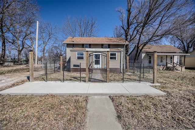 view of front of house featuring a fenced front yard and a gate