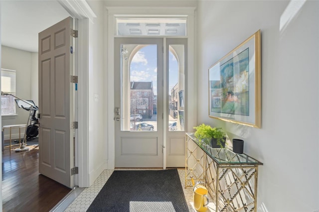 entryway with dark wood-style floors and baseboards