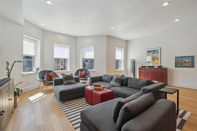 living area with recessed lighting, baseboards, and light wood finished floors