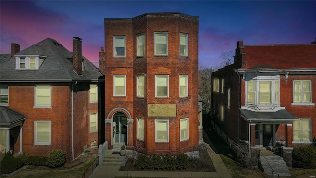 townhome / multi-family property featuring brick siding