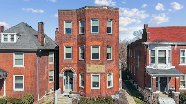 view of property featuring brick siding