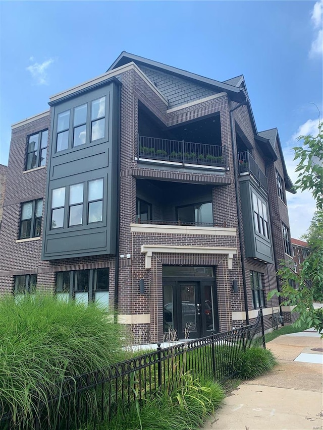 view of building exterior with a fenced front yard