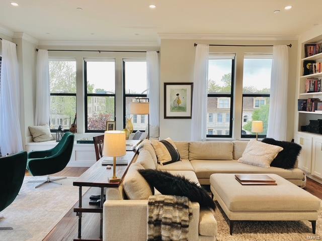 living area featuring ornamental molding, recessed lighting, and wood finished floors