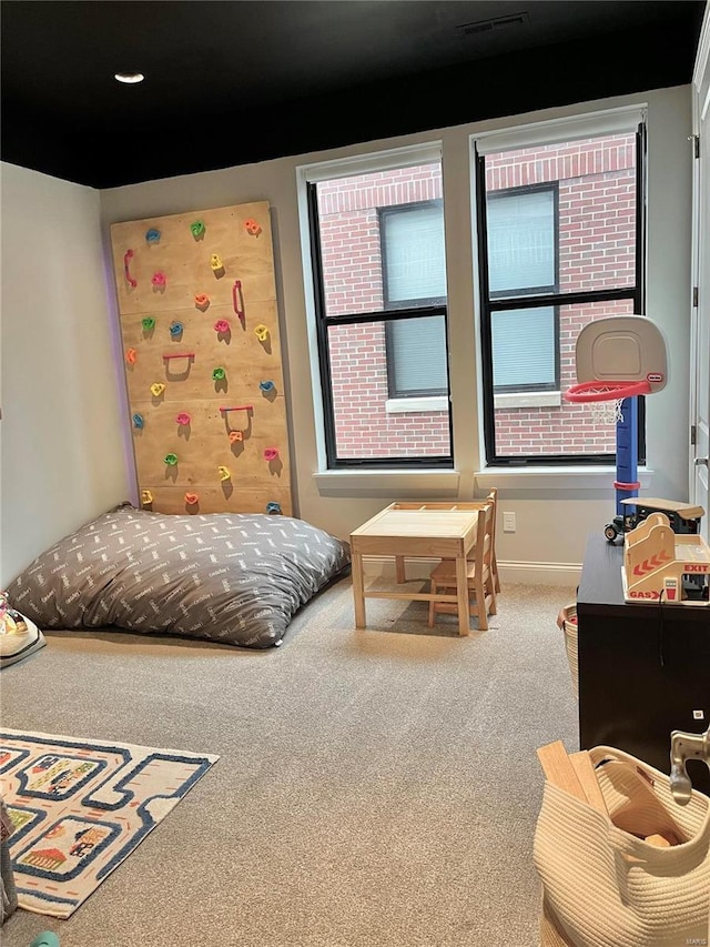 carpeted bedroom with visible vents and baseboards