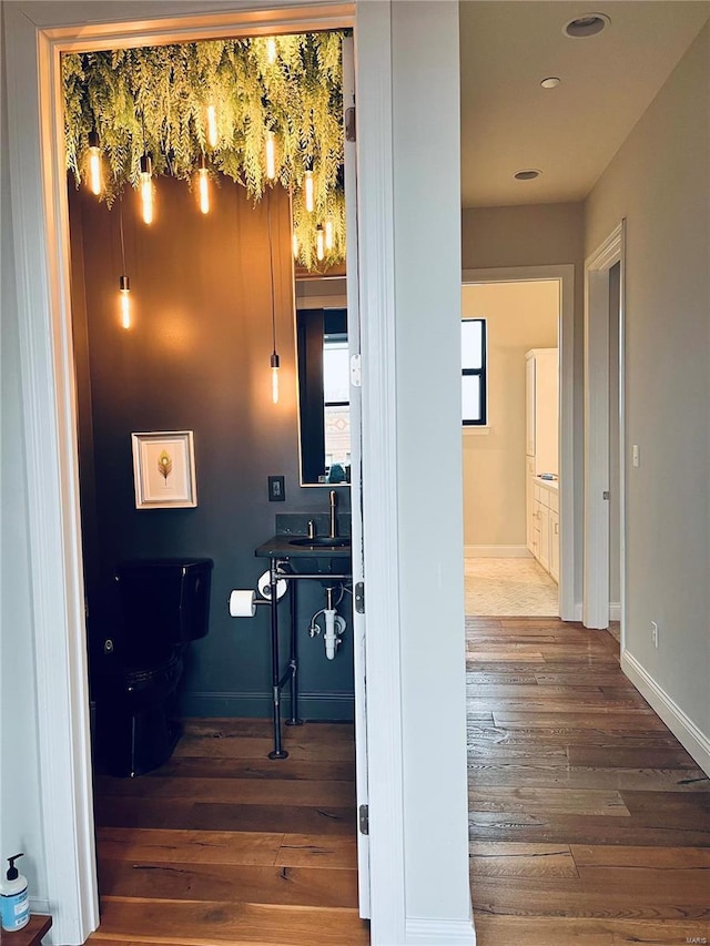 hall with hardwood / wood-style flooring and baseboards