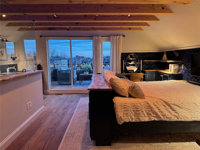 bedroom featuring vaulted ceiling with beams, access to exterior, baseboards, and hardwood / wood-style flooring