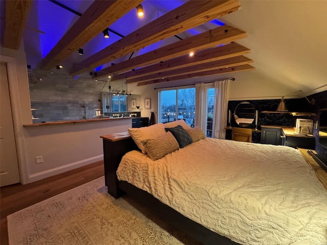 bedroom with wood finished floors, beam ceiling, and baseboards