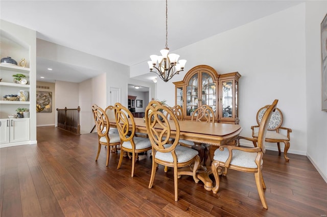 dining space with dark wood-type flooring, a chandelier, baseboards, and built in features