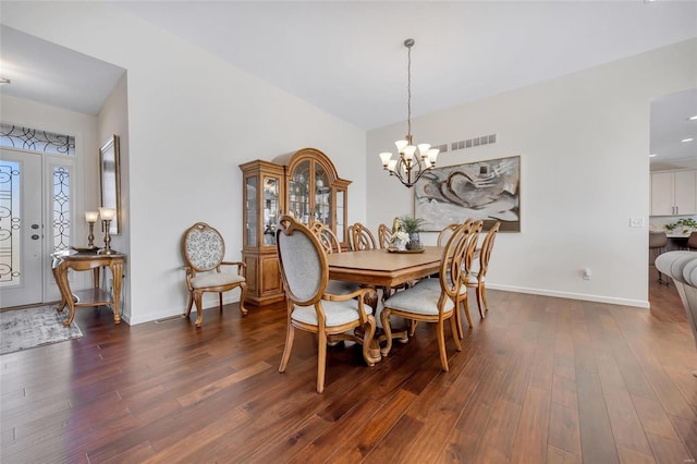 dining area with baseboards, dark wood-style flooring, visible vents, and a notable chandelier