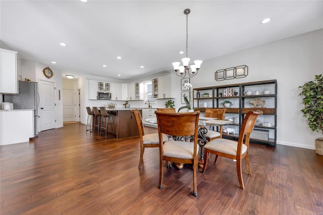 dining space with dark wood-style floors, a chandelier, and recessed lighting