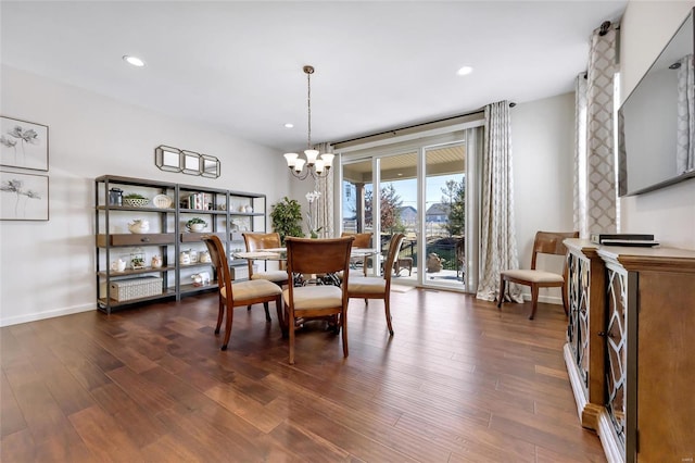 dining area with dark wood-type flooring, recessed lighting, baseboards, and an inviting chandelier