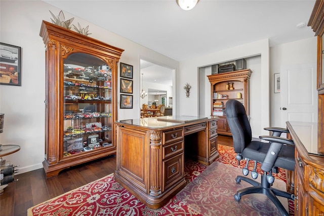 office space featuring baseboards and dark wood-type flooring