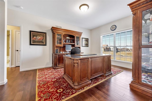 office space with dark wood-style floors, visible vents, and baseboards