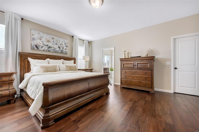 bedroom featuring dark wood finished floors and baseboards