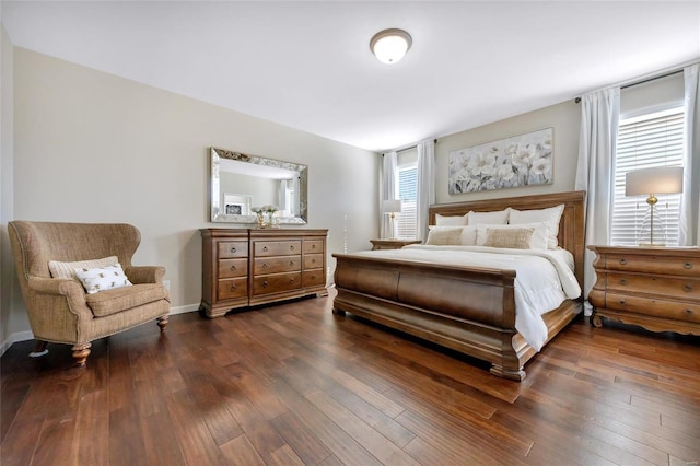 bedroom featuring dark wood finished floors and baseboards