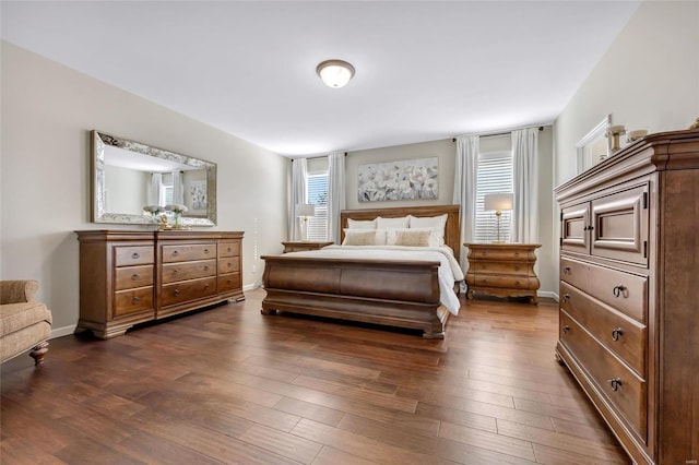 bedroom with dark wood-style floors and baseboards