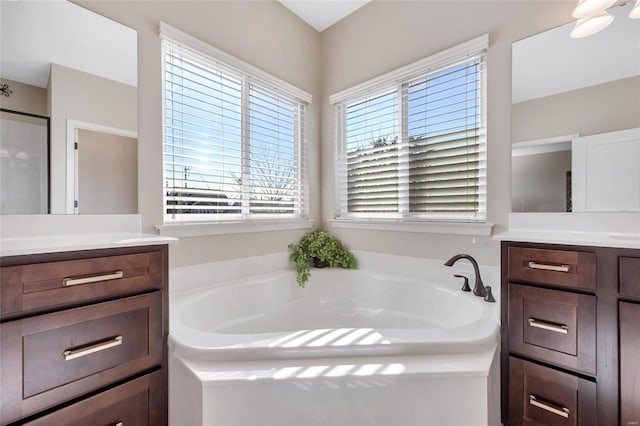 full bathroom featuring a bath and vanity