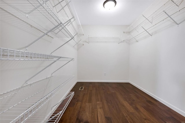 walk in closet with wood finished floors and visible vents