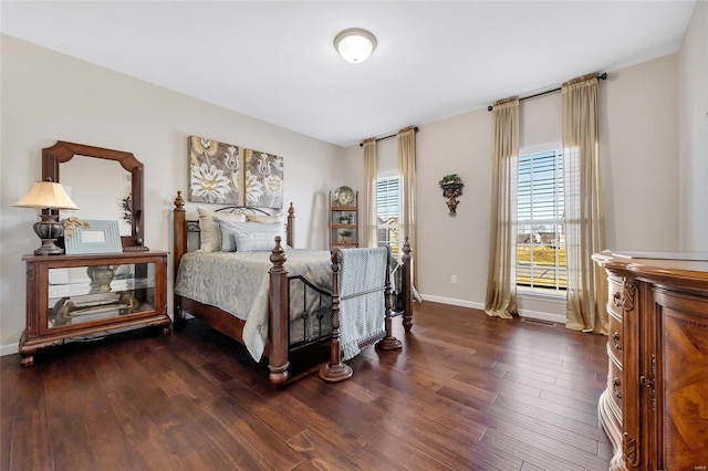 bedroom with baseboards and wood finished floors