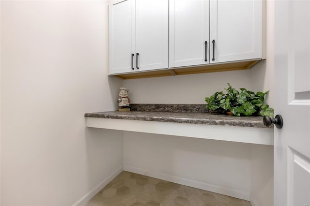 interior details with baseboards and tile patterned floors