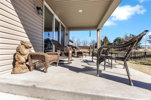 view of patio / terrace featuring an outdoor hangout area and fence