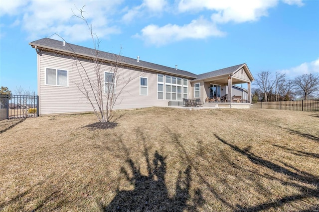 back of property with a patio area, fence, and a yard