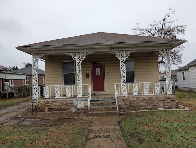 view of front of property with covered porch and roof with shingles