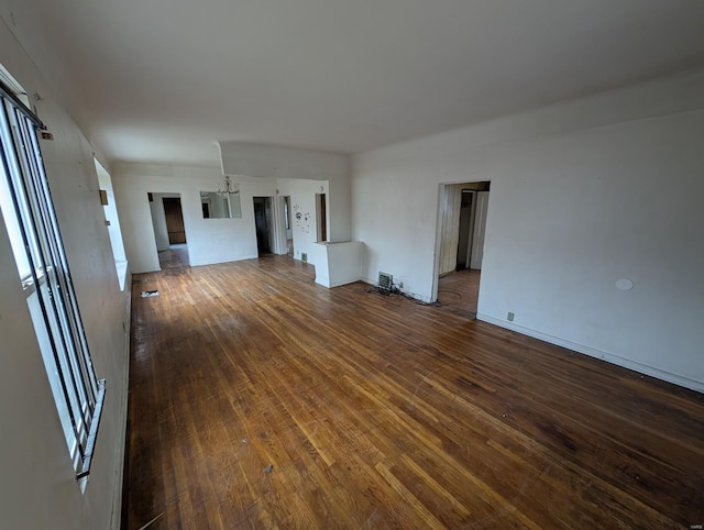 unfurnished living room featuring dark wood-style flooring