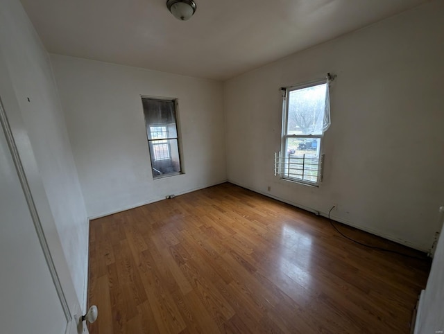 unfurnished room with wood finished floors