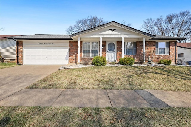 view of front of property featuring brick siding, driveway, a front yard, and a garage