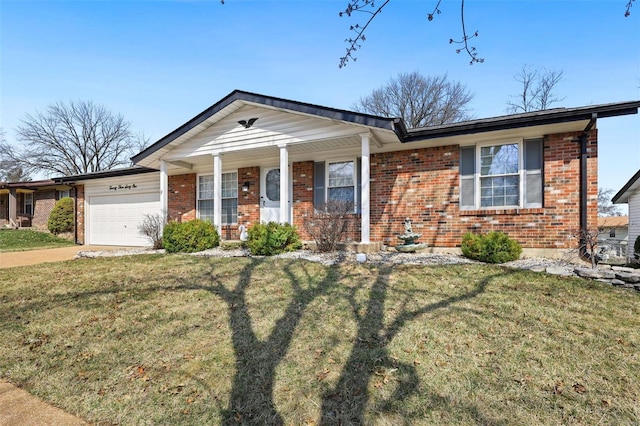 view of front of property featuring driveway, a front lawn, brick siding, and an attached garage