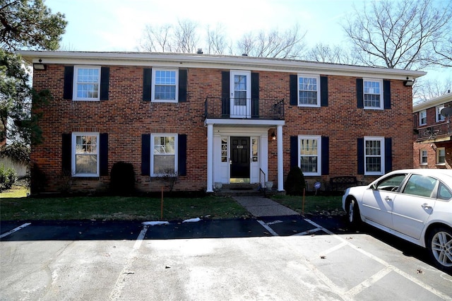 view of front of house featuring uncovered parking and brick siding