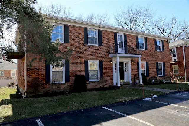 view of front facade featuring uncovered parking and brick siding