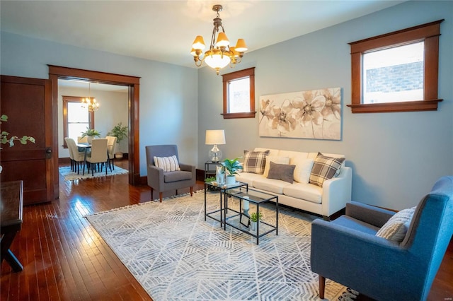 living room featuring wood-type flooring and a notable chandelier