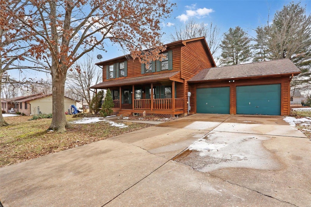 view of front of home featuring a garage, covered porch, a shingled roof, and concrete driveway