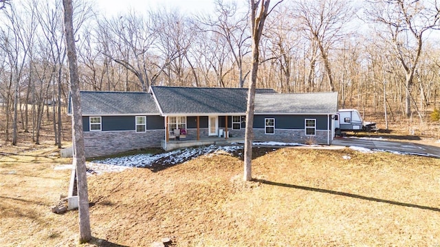 ranch-style house with stone siding and a porch