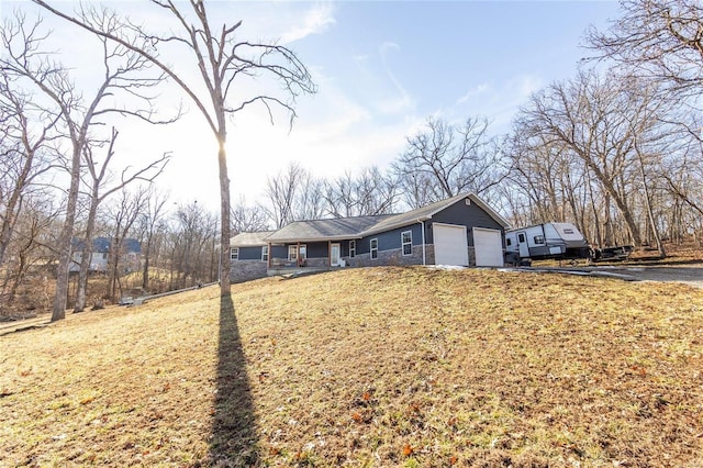 ranch-style home with a garage and a front yard