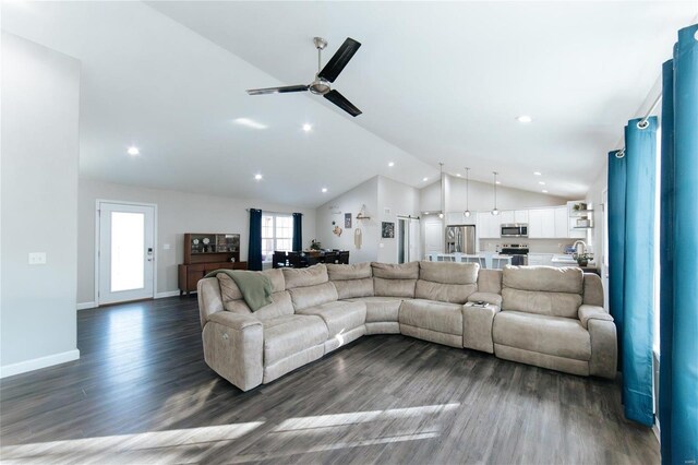 living room with dark wood-type flooring, recessed lighting, vaulted ceiling, and baseboards