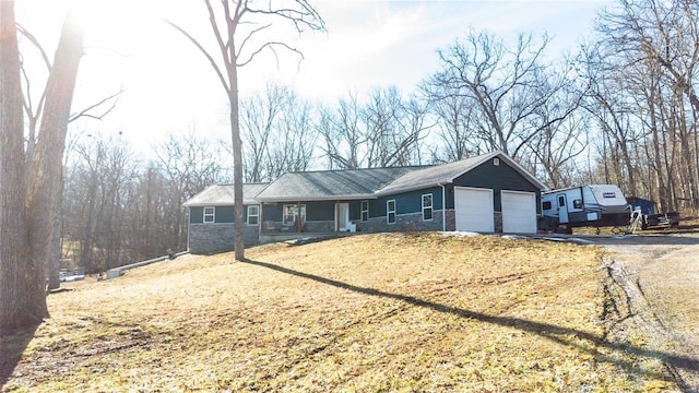 ranch-style house with an attached garage, stone siding, and covered porch