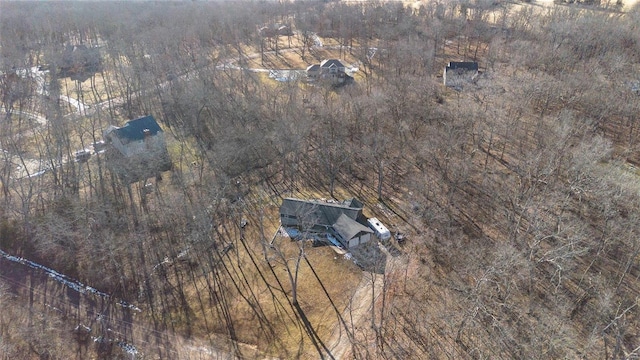 birds eye view of property with a view of trees