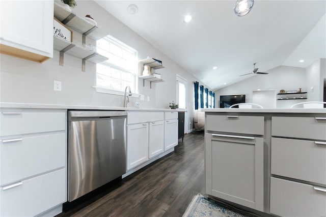 kitchen with white cabinets, vaulted ceiling, light countertops, stainless steel dishwasher, and open shelves