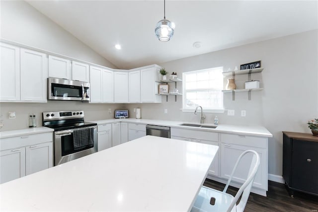 kitchen with a sink, white cabinetry, vaulted ceiling, appliances with stainless steel finishes, and open shelves